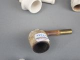 a pipe that has a sticker on it next to other pipes
