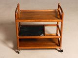 a small wooden cart with two shelves on it