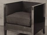 a black and white photo of a chair in a room
