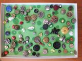 a box filled with lots of buttons on a table
