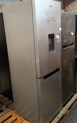 several refrigerators are stacked on pallets in a warehouse