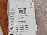 two pieces of clothing on a table with a price tag on it