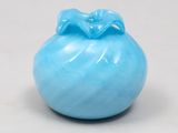 a blue vase sitting on a table with a white background