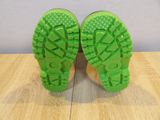 the soles of a pair of green shoes on a wooden floor