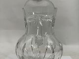 a clear glass vase sitting on top of a piece of paper