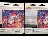 two packs of pokemon trading cards on a black background