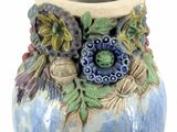 a blue and white vase with a flower decoration on it