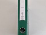 an image of a green binder sitting on top of a white table