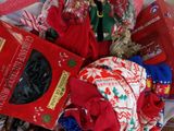 a pile of christmas presents in a basket on the floor