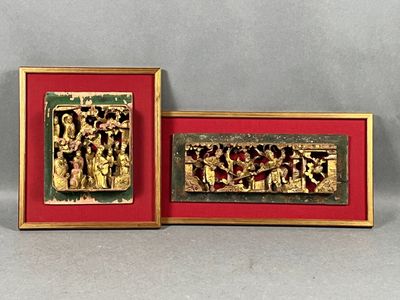 pair of gold and red picture frames with figures on them