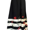 the skirt is black and white with red flowers on it