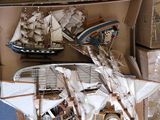 a lot of small model ships on display in a box