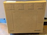 a box sitting on the floor in front of a refrigerator