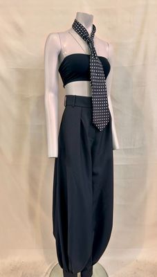 a mannequin wearing a black dress and a tie