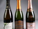 three bottles of champagne sitting next to each other on a table