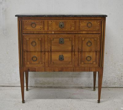 a small wooden chest of drawers with a marble top