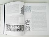an open book with a picture of a man in a cave
