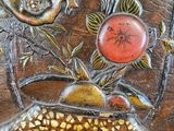 a wooden plate with a bird and flowers on it