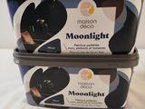 two containers of moonlight yogurt sitting on a table