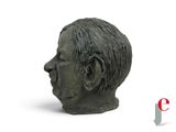 a statue of a man ' s head on a white surface
