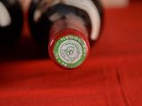 a close up of a bottle of wine on a red cloth