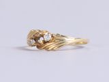an image of a gold ring with two diamonds