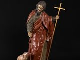 a statue of a man with a dog and a cross