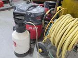 a hose and a spray gun on the floor