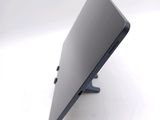 a laptop that is sitting on a stand on a white surface