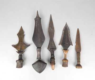 four different types of weapons are displayed on a white surface