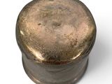a metal container with a metal lid on a white surface