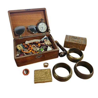 a wooden box filled with assorted items including a watch, bracelets, and other items