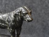 a statue of a dog that is standing on a table