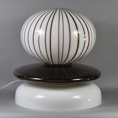 a lamp that is on top of a white base