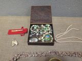 a box with a bunch of jewelry on a table