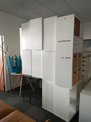 a room with white cabinets and a brown couch in it