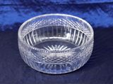 an image of a clear glass bowl sitting on a blue cloth