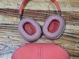 pair of pink headphones and eye mask laying on a wooden floor