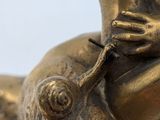 a bronze statue of a frog with a snail on its back