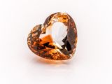 an orange diamond on a white surface with a white background