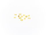 a close up of a group of gold rings on a white surface