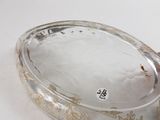 a glass bowl with a lid on a white table
