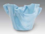 a close up of a blue vase on a gray background