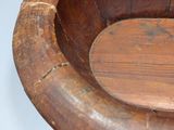 a wooden bowl that is sitting on a table