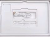a white box with a pair of ear buds and a charger