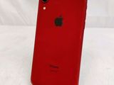 the back of a red iphone xr sitting on top of a white surface