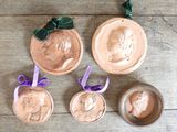 four different types of clay ornaments on a wooden table