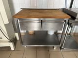 a small table with two cups on it in a kitchen