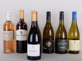 several bottles of wine are lined up on a table