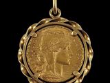 a close up of a gold coin on a black background